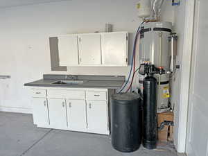 Utilities with water heater, sink, and electric panel