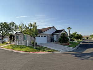 View of front of house with a garage and a front lawn