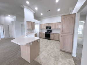 Kitchen featuring light colored carpet, range with electric cooktop, sink, and kitchen peninsula