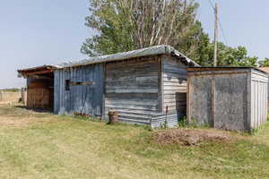 View of outbuilding featuring a lawn