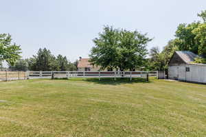 View of yard with a storage shed and a rural view