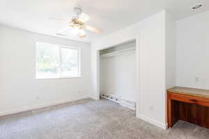 Unfurnished bedroom with light colored carpet, a closet, and ceiling fan