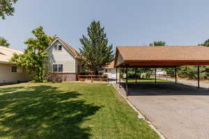 Exterior space featuring a carport and a lawn