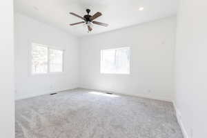 Empty room featuring carpet floors and ceiling fan