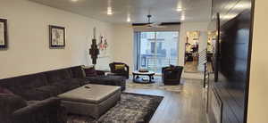 Living room with wood-type flooring and ceiling fan