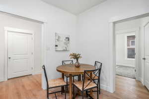 Dining room with light hardwood / wood-style flooring