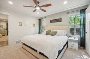 Carpeted bedroom with ceiling fan