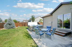 View of yard featuring a patio, a deck, and a hot tub