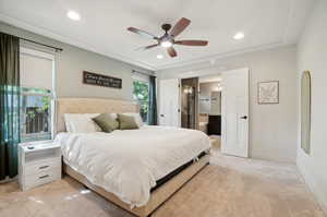 Carpeted bedroom with ensuite bath and ceiling fan