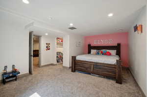 Bedroom featuring light colored carpet