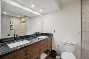 Bathroom with toilet and dual bowl vanity.   Radiant heated floors and shower