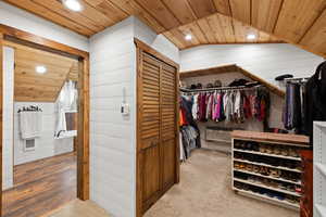 Spacious closet with carpet flooring and vaulted ceiling