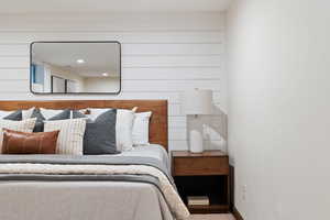 Bedroom featuring wooden walls