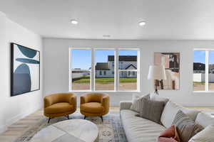 Living room with plenty of natural light and light hardwood / wood-style flooring