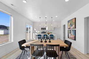 Dining space with light wood-type flooring