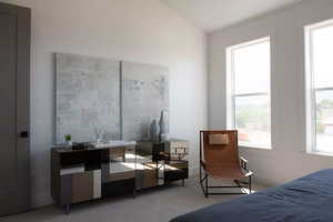 Bedroom with carpet flooring and lofted ceiling