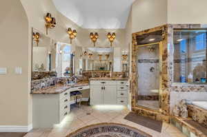 Master Bathroom x2 featuring tile patterned flooring, shower with separate bathtub, and vanity