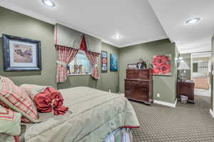 Bedroom featuring carpet floors and ornamental molding