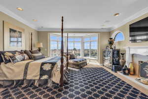 Carpeted bedroom with crown molding