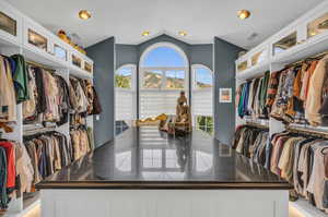 Walk in closet featuring lofted ceiling