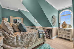 Bedroom featuring crown molding and light wood-type flooring