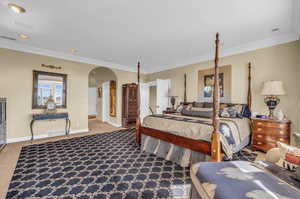 Carpeted bedroom featuring ornamental molding