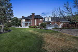 Back of property featuring a patio and a yard