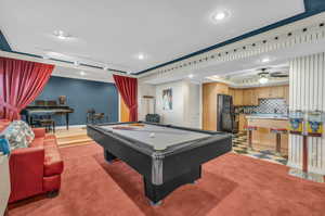 Recreation room featuring track lighting, pool table, carpet flooring, ceiling fan, and ornamental molding