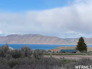 Property view of mountains featuring a water view