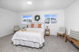 Bedroom featuring light carpet