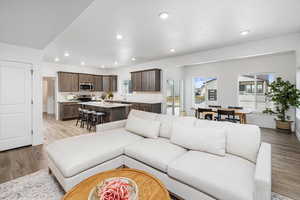 Living room featuring sink and light hardwood / wood-style flooring