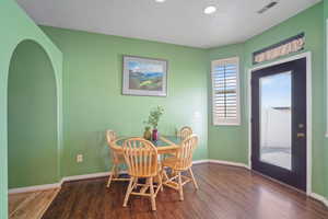 Dining room featuring a textured ceiling and hardwood / wood-style flooring