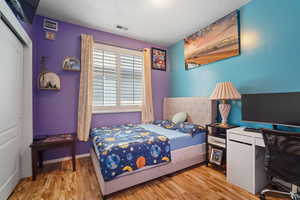 Bedroom featuring a closet and light wood-type flooring