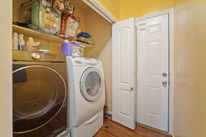 Laundry room featuring washing machine and dryer and hardwood / wood-style floors