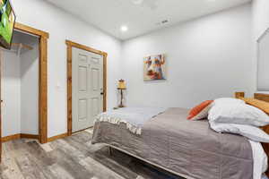 Bedroom featuring hardwood / wood-style floors and ceiling fan