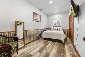 Bedroom with hardwood / wood-style floors