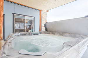 View of patio / terrace featuring a hot tub