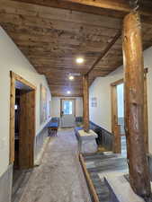 Interior space with dark hardwood / wood-style flooring, wooden ceiling, and lofted ceiling