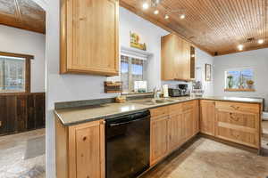 Kitchen with dishwasher, light brown cabinets, sink, kitchen peninsula, and wood ceiling