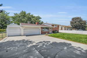 View of front of house with a garage and a front lawn