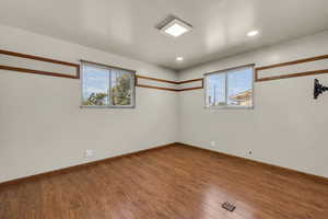 Spare room featuring wood-type flooring