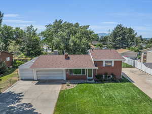 View of front of property with a garage and a front yard