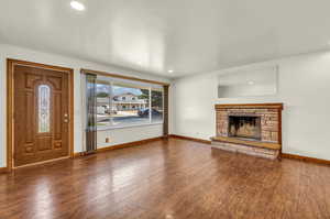 Unfurnished living room featuring a fireplace and wood-type flooring