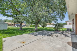 View of patio featuring a storage unit