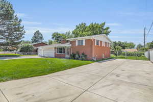 View of front facade with a garage and a front yard