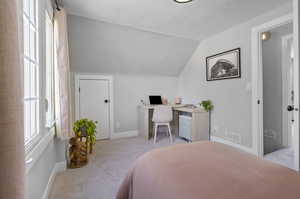 Carpeted bedroom with vaulted ceiling