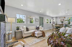 Living room featuring a tile fireplace and light hardwood / wood-style flooring