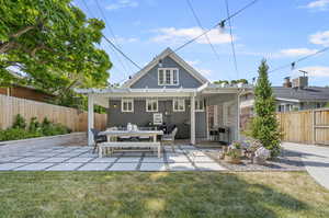 Rear view of property featuring a patio area and a lawn