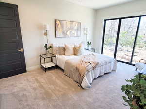 Bedroom featuring light colored carpet and access to outside