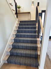 Stairs featuring wood-type flooring